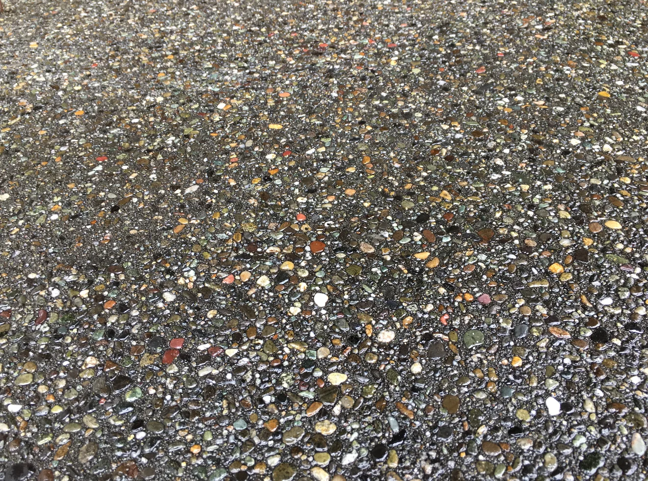 Exposed aggregate concrete finish with decorative stones